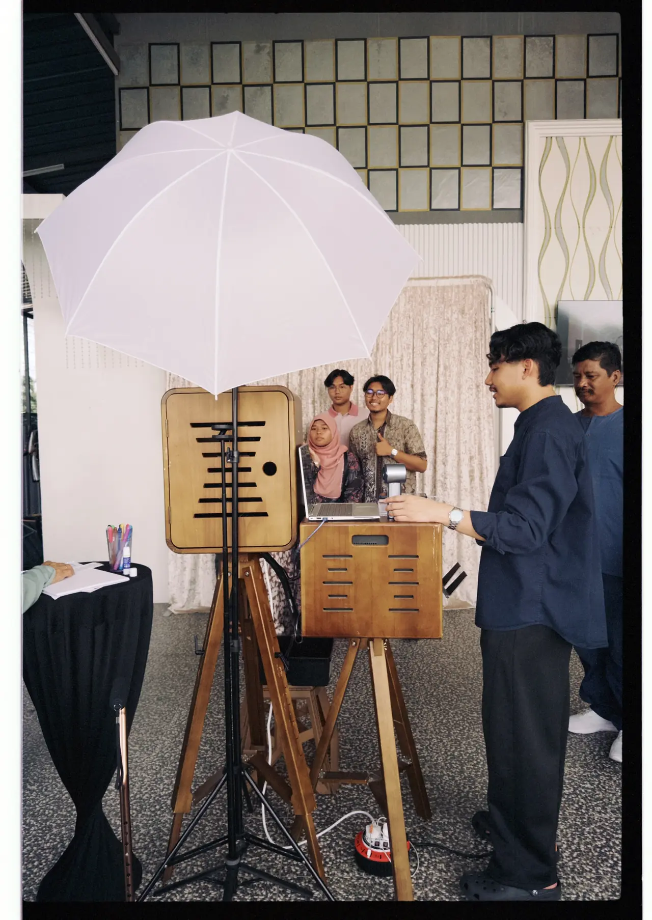 The vintage photobooth set up at an event, crew helping guests pose